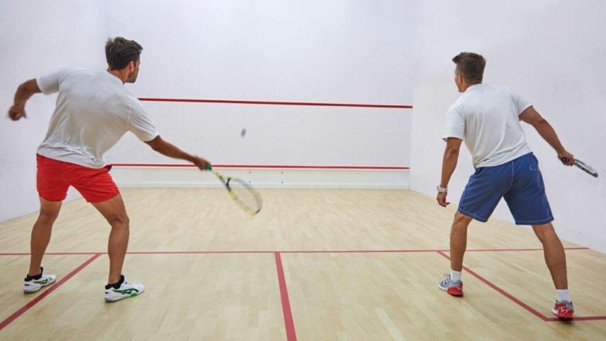 Squash is a game played by 2 players with rackets and a ball with the aim of hitting the ball alternately