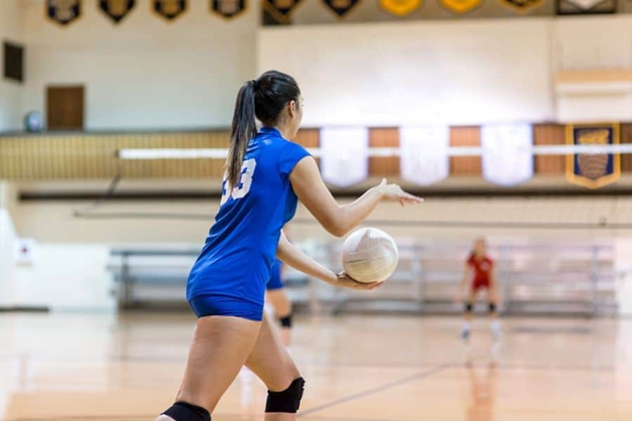 The game in traditional volleyball starts with a player serving the ball behind the backline