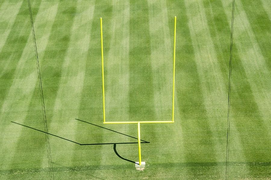 Though the goalposts' height varies on the play level, they must be 10 ft tall for high school and college football, and 20 ft for NFL